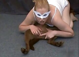 Mask-wearing blonde zoophile enjoying hot cunnilingus with a dog